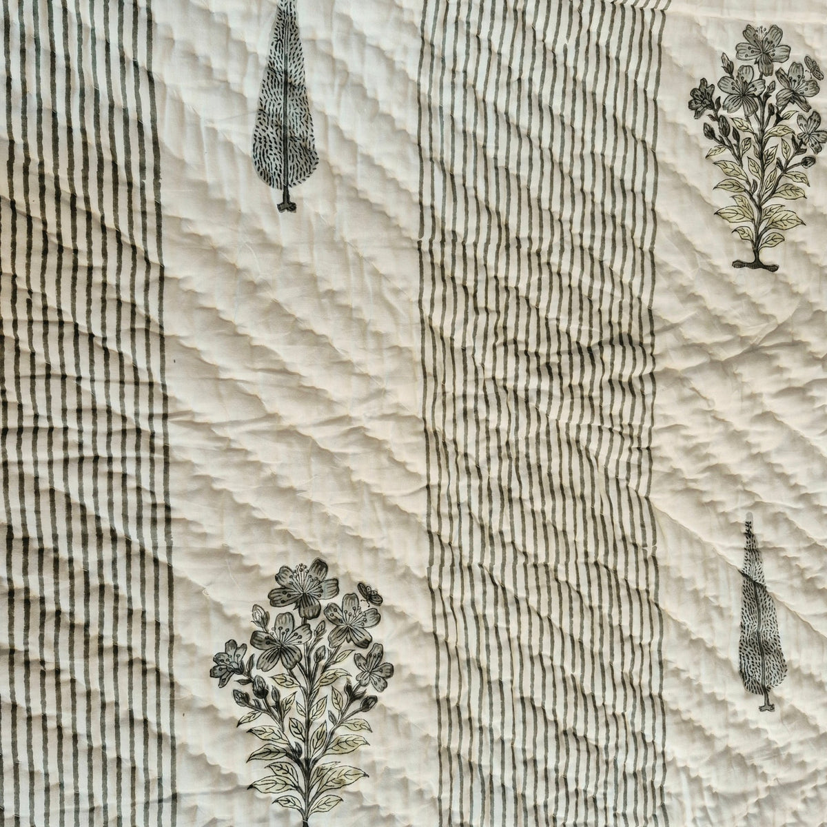 Reversible block print single quilt with a cypress tree and flower print in a plain white background design