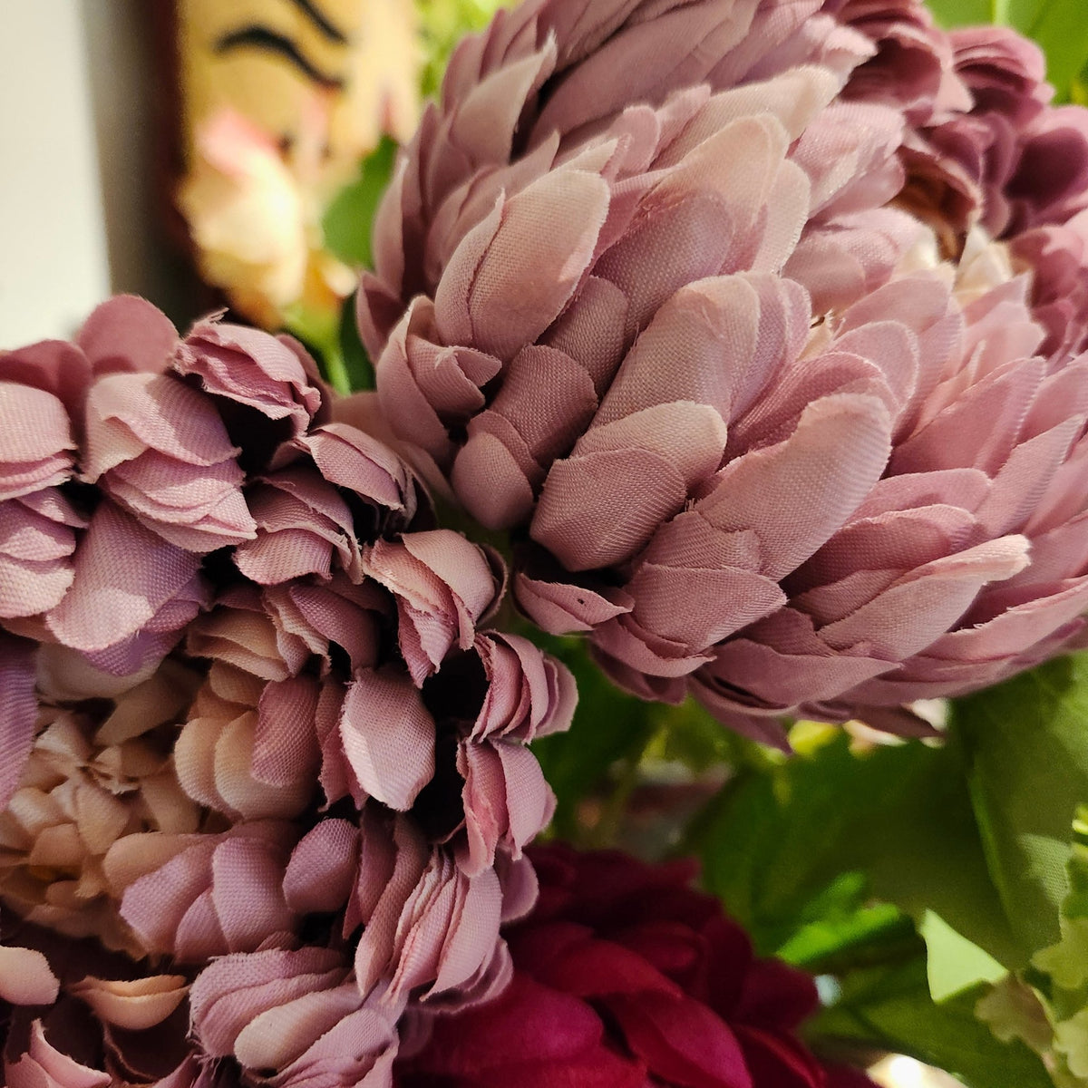 Artificial peony in lilac shown in a home setting, one of the five colours that the flower is made in