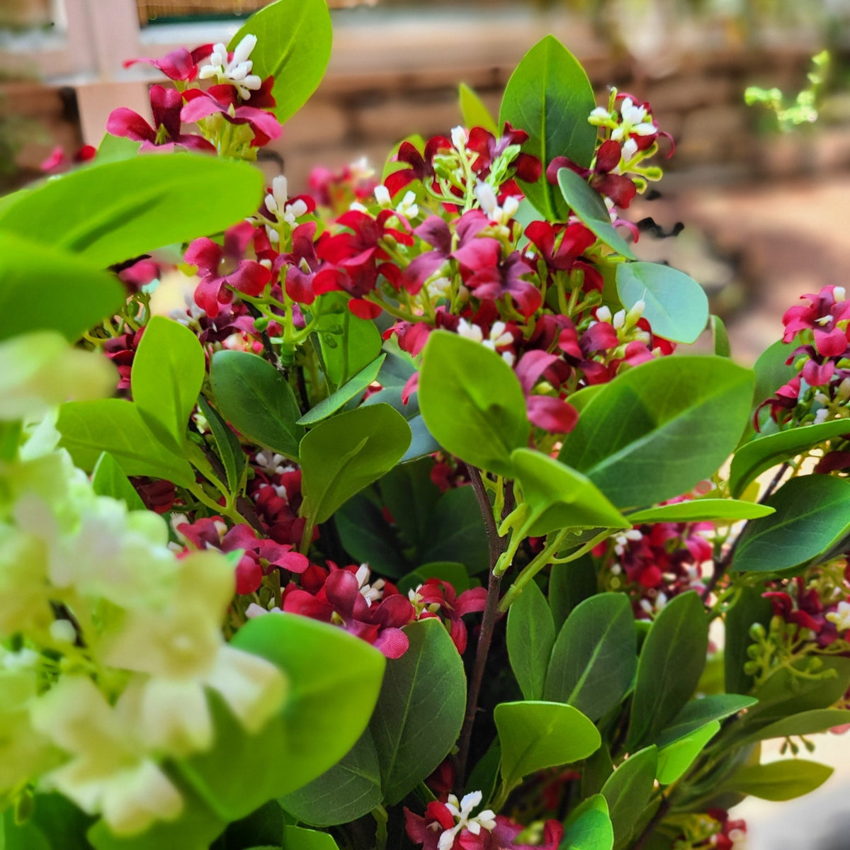 Artificial jasmine in red, with delicate lifelike flowers for a vase or a longer lasting arrangement