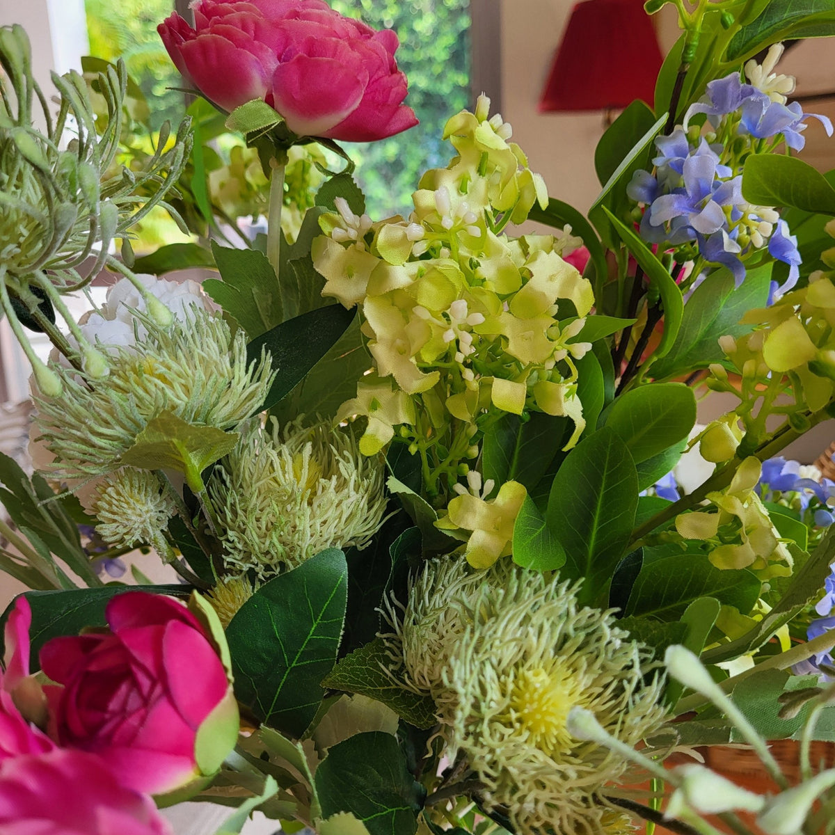 A spring bouquet of artificial stems including the ranunculus, whose flowers come in pink or cream