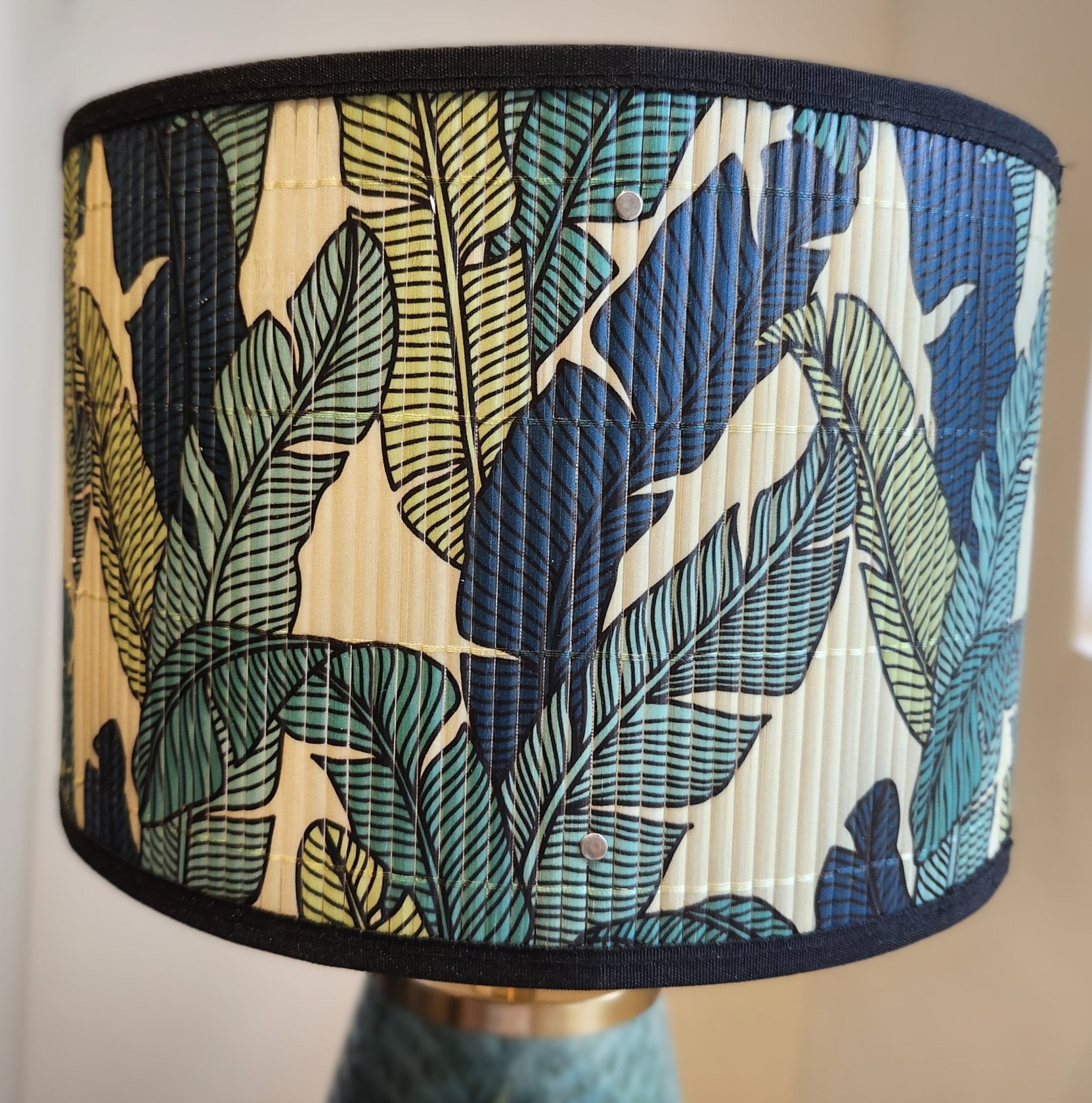 Green leaf-glazed ceramic table lamp with brass fittings and a screenprinted bamboo shade, 39cm high, made in Vietnam