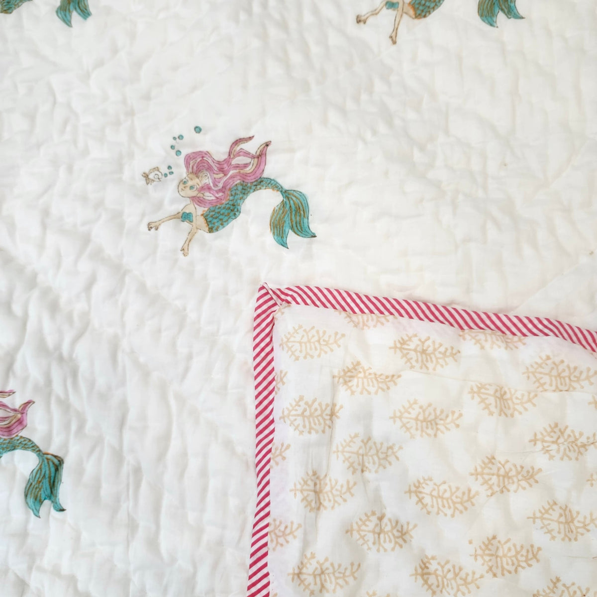 Child's mermaid quilt measuring 40 x 60 inches, about 102 x 152 cm, with a yellow patterned reverse side