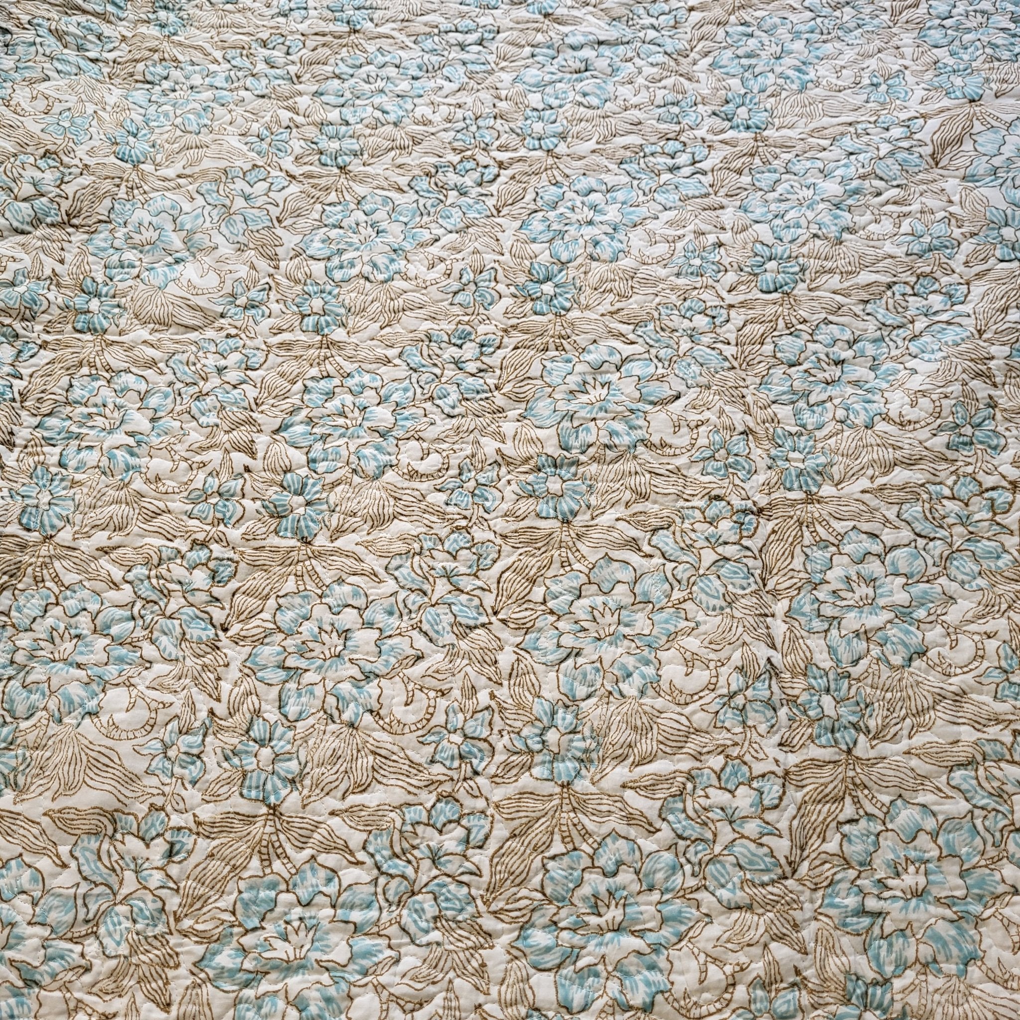 Block-print quilted king bedspread with pillowcases in blue and pink, from Inside Living Singapore Front view.