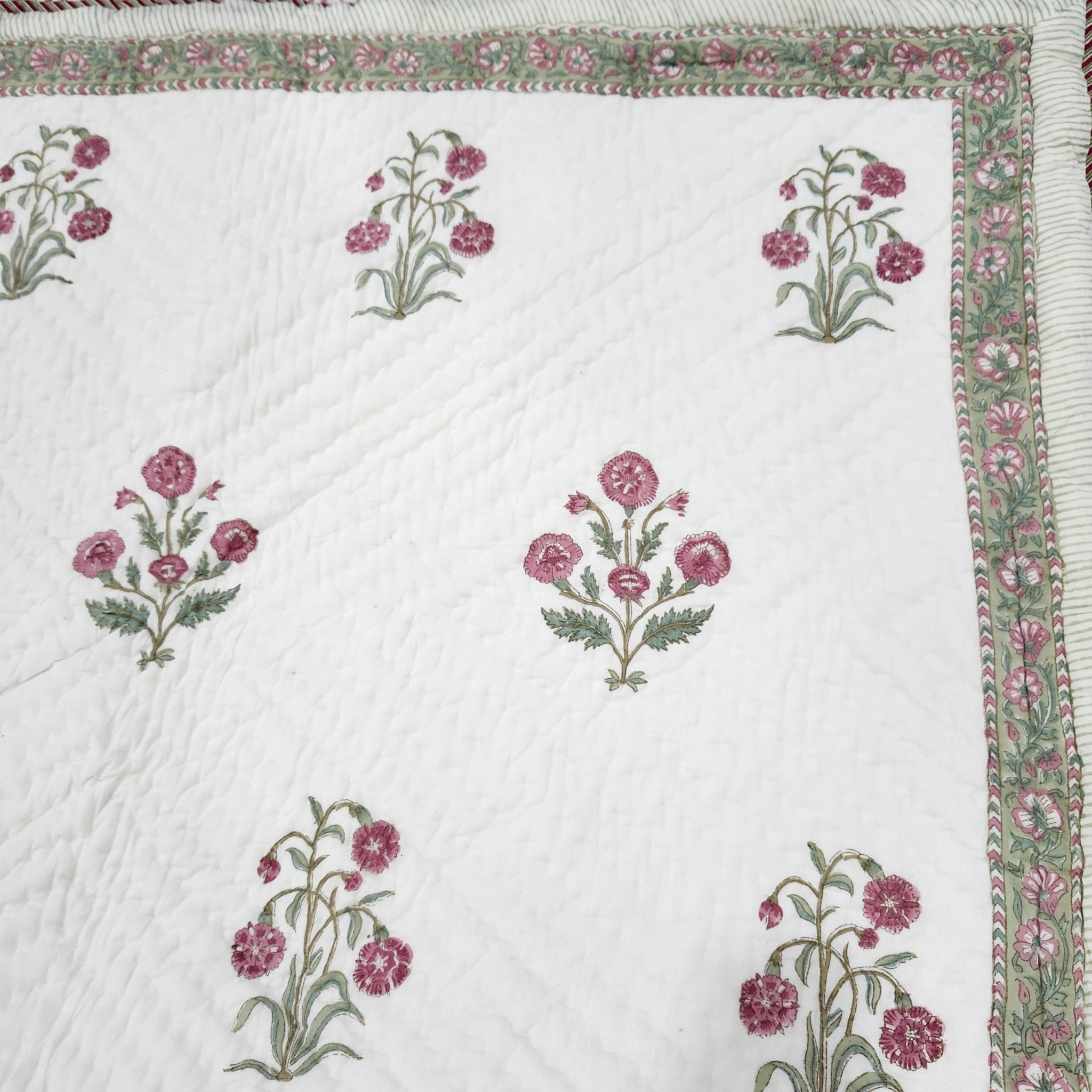 Detail of the hand carved block print technique used on this reversible single cotton quilt.
