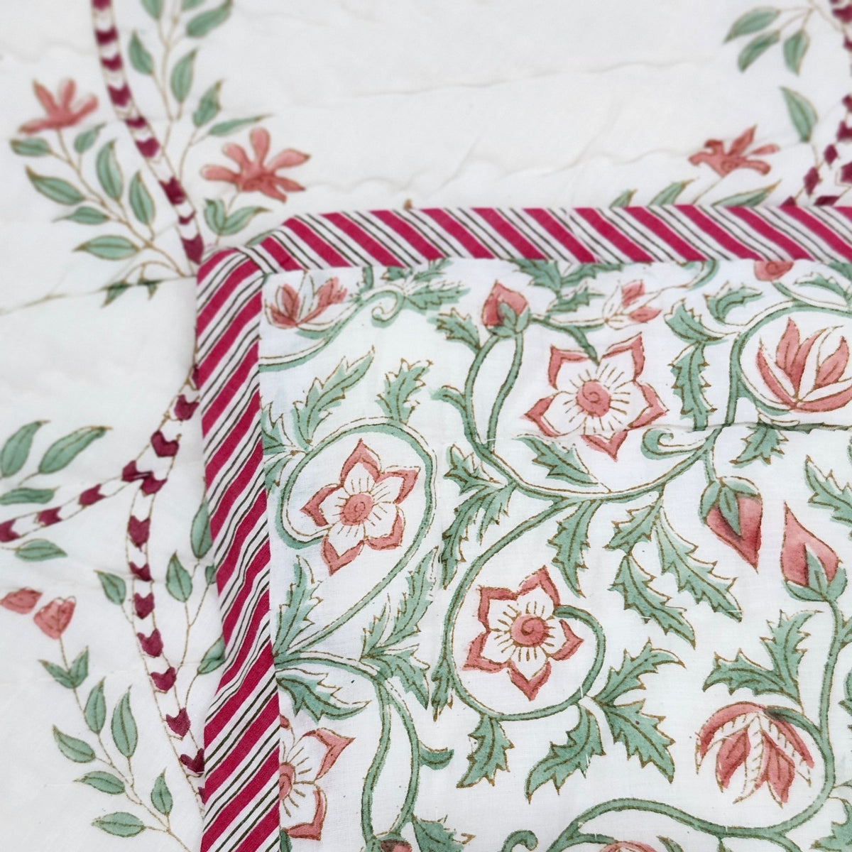 Green block print single quilt with a trellis print on a white background, reversible to a floral print