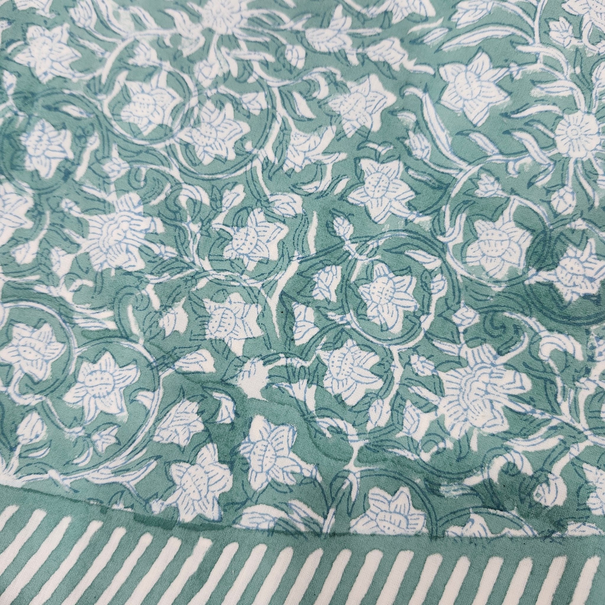 Block print cotton tablecloth in floral green, handmade hand-printed cloth for the dining table, detail view
