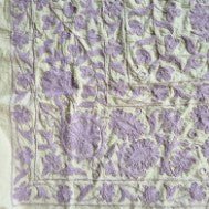 Hand embroidered Suzani throw in lavender on a pale green cotton base, 150cm x 225cm, made in India.