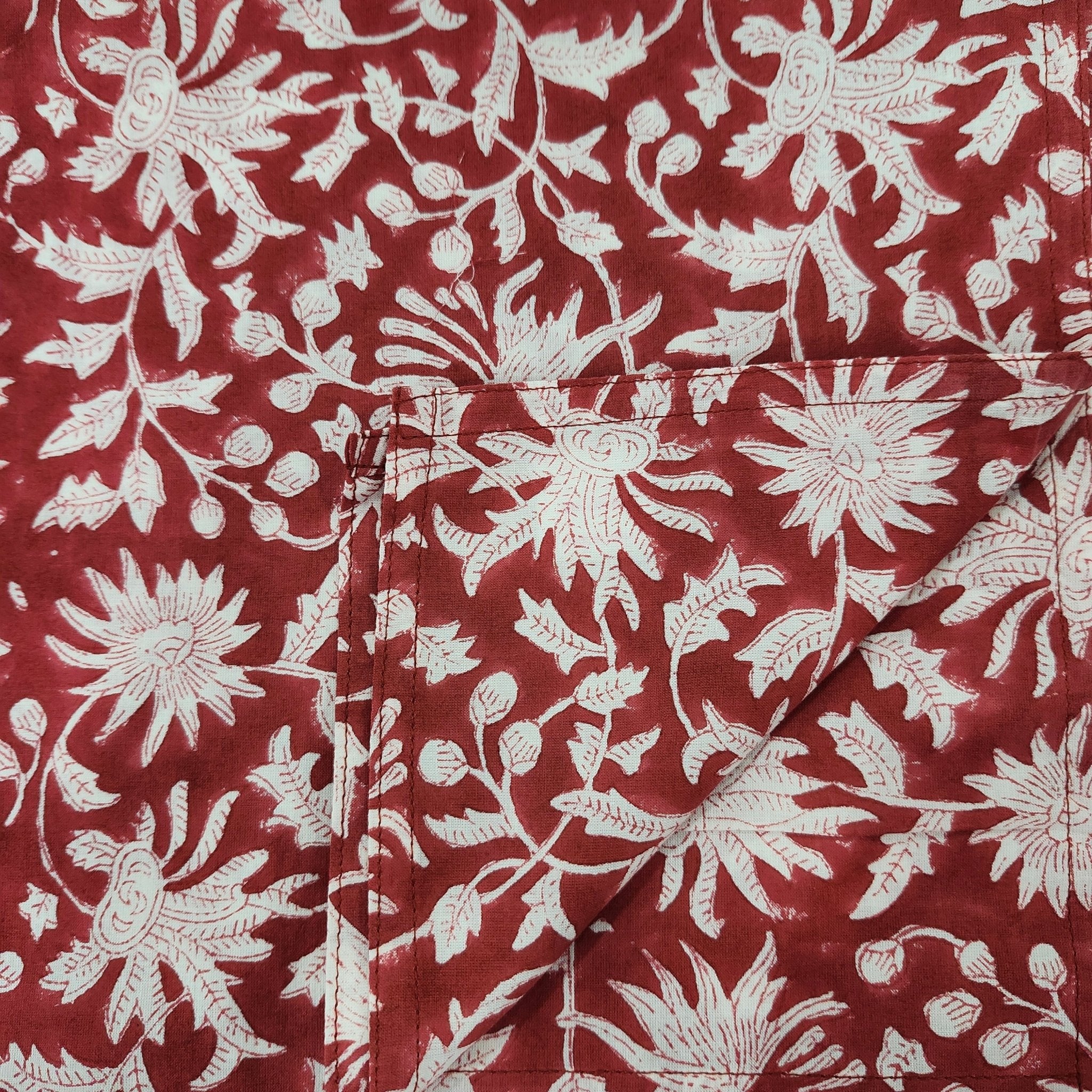 Block print cotton tablecloth in festive red, handmade hand-printed cloth for the dining table, close-up view