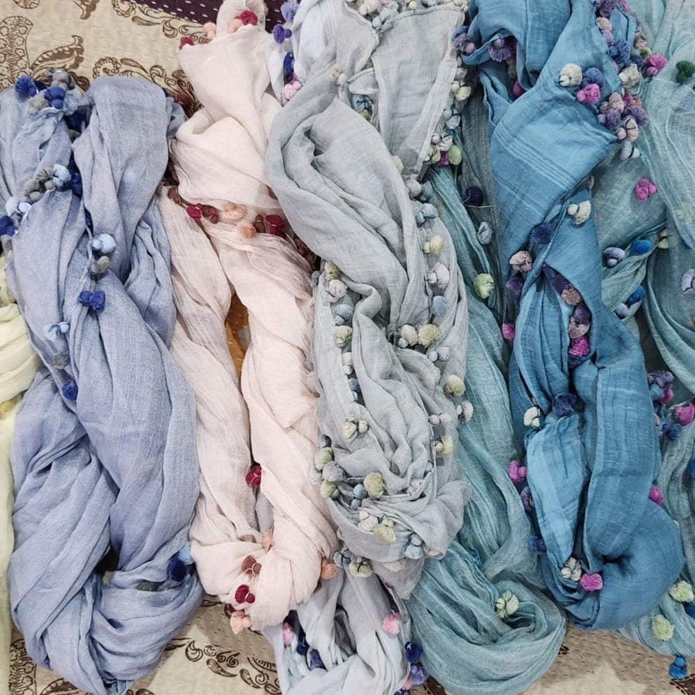Lightweight hand-dyed cotton scarf in pastel shades, trimmed with tiny pom poms, two sizes