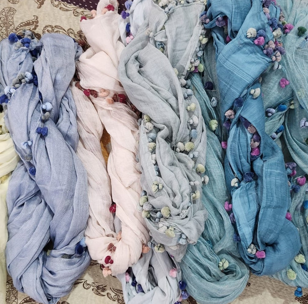 Lightweight hand-dyed cotton scarf in pastel shades, trimmed with tiny pom poms, two sizes