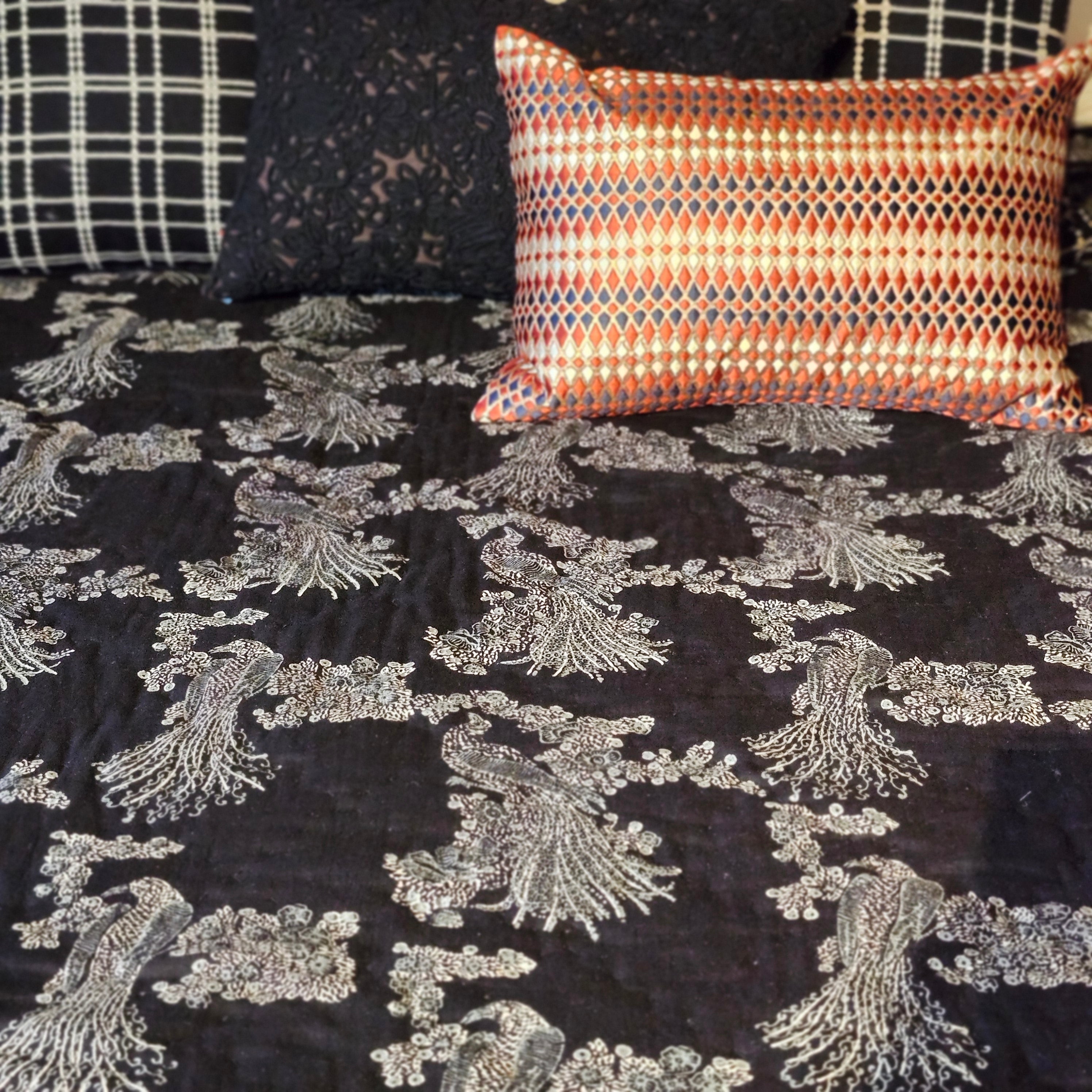 Cotton voile quilt block-printed with silver birds of paradise on black, hand-quilted, in queen and king sizes