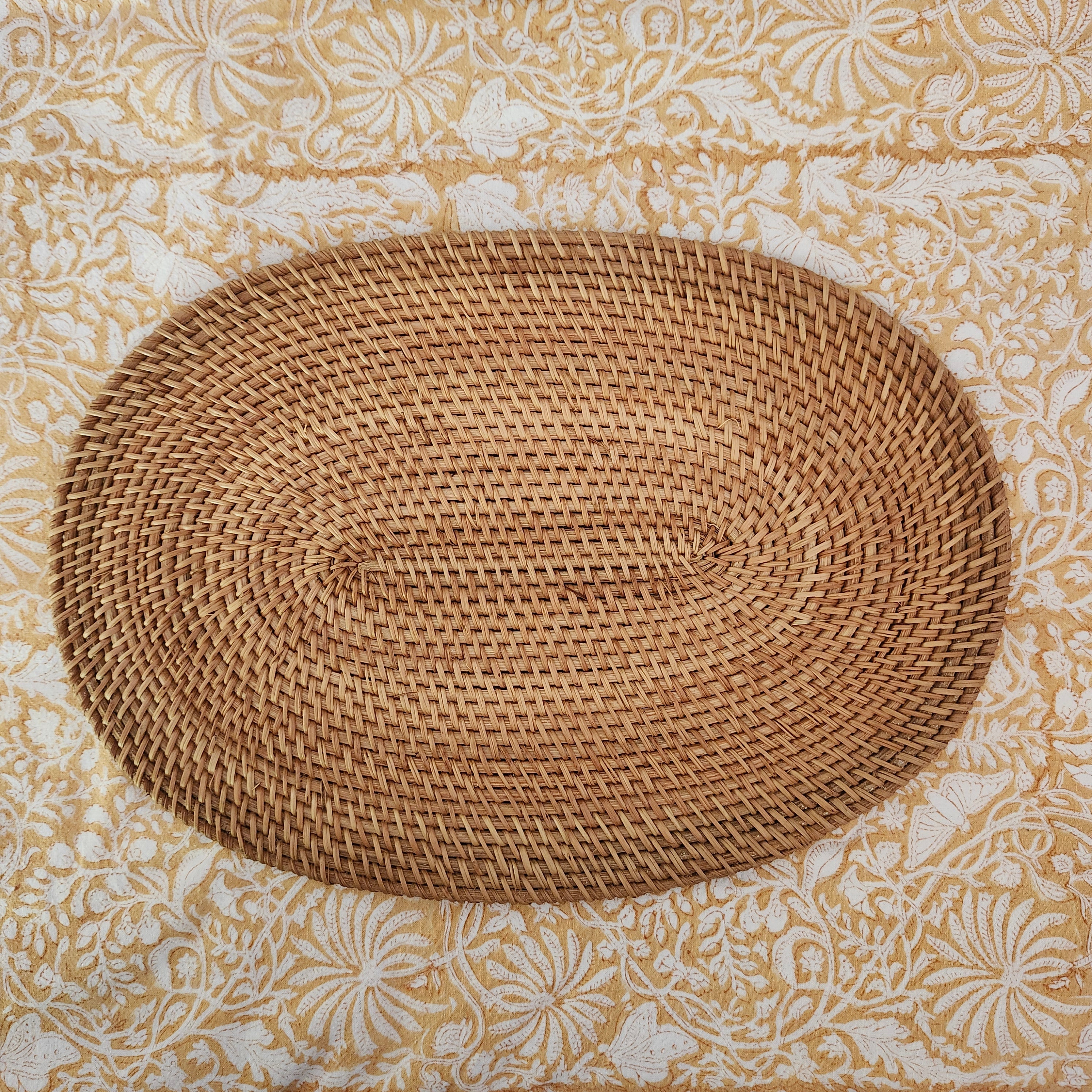 Oval handwoven natural rattan placemat, lightweight table mat for everyday and special dining, close-up view
