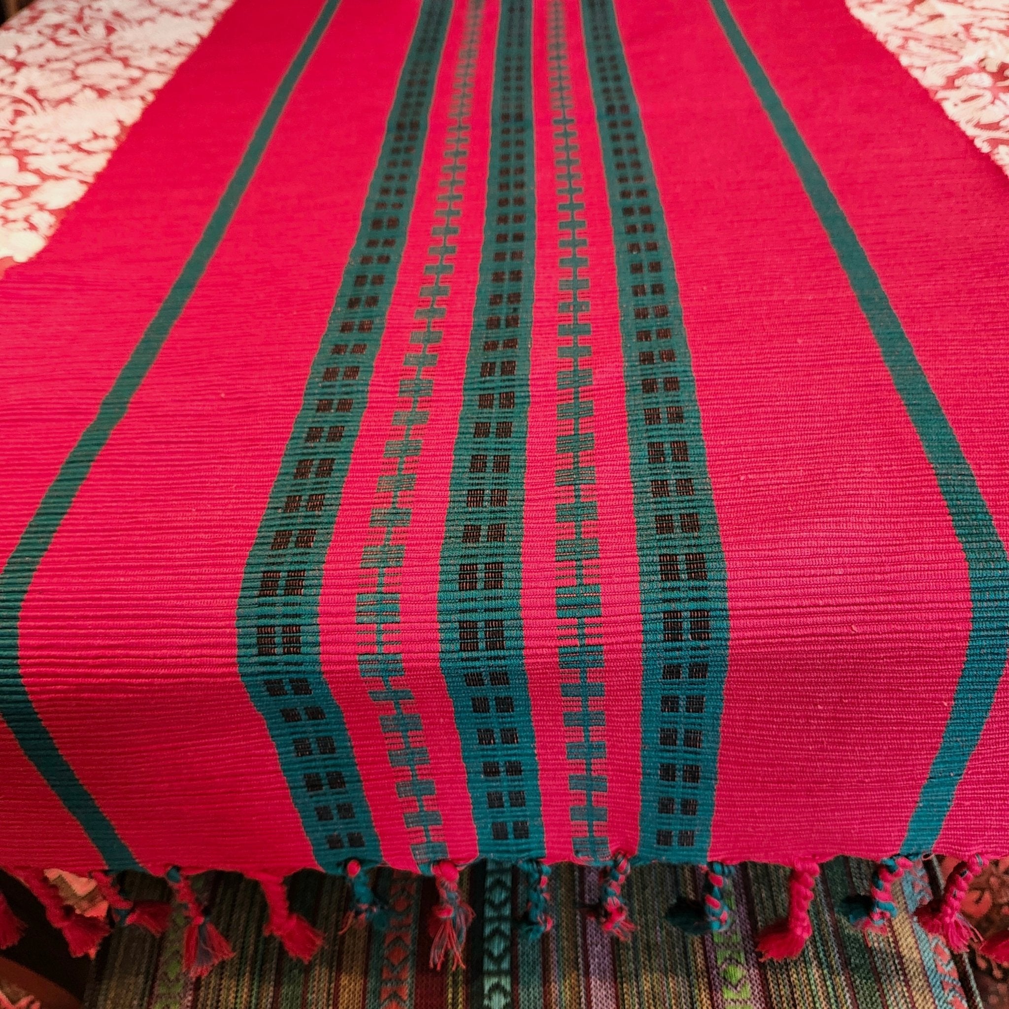 Handwoven cotton table runner in bold red and green, for festive tables, available in three sizes