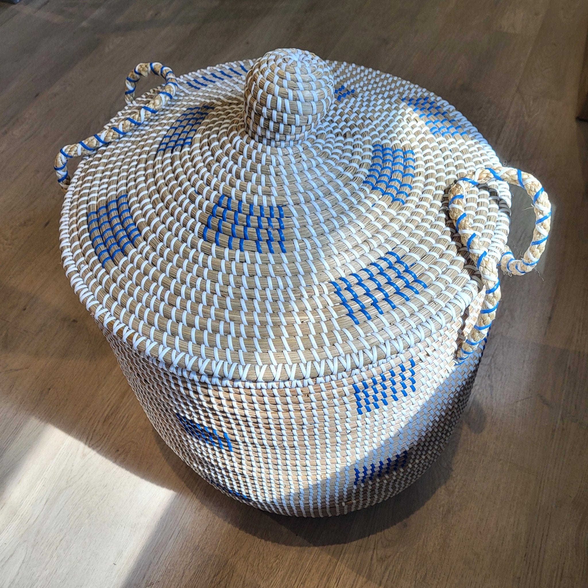 Blue seagrass laundry basket with lid from Inside Living, woven natural-fibre storage hamper for the home, styled in situ