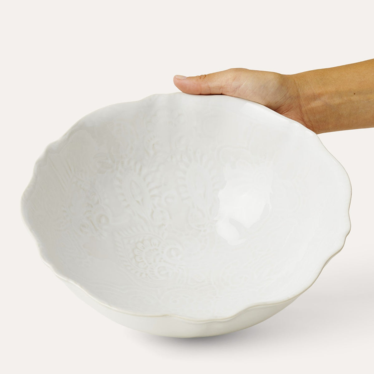 Close view of the white glaze on the scalloped serving bowl, showing the delicate pattern in the surface