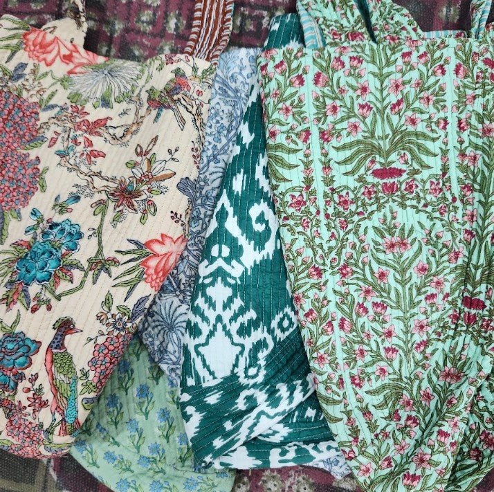 V-shaped block printed cotton tote bag with two shoulder handles and side ties, 55 x 40cm, with a contrast print lining.