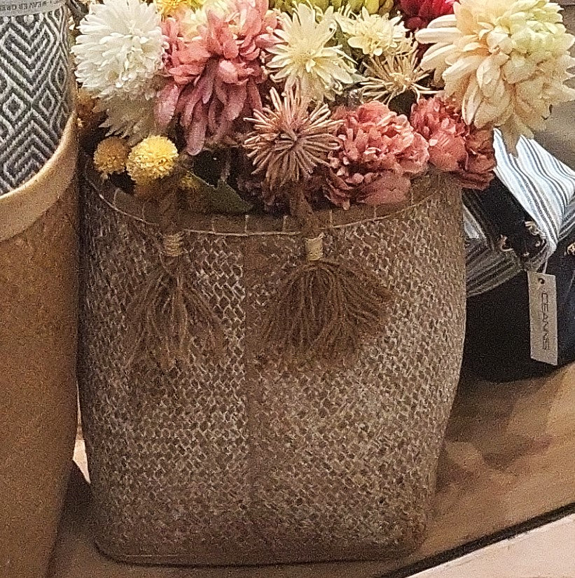 White wicker laundry basket detail, handwoven white wicker storage basket, a practical decorative home organiser.