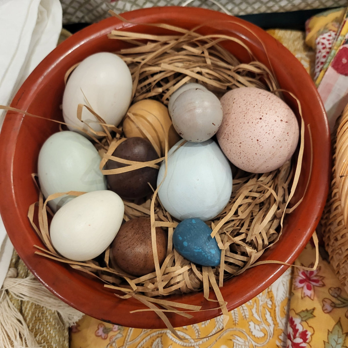 Set of a dozen painted wooden eggs in assorted sizes and colours, a sustainable Easter decoration