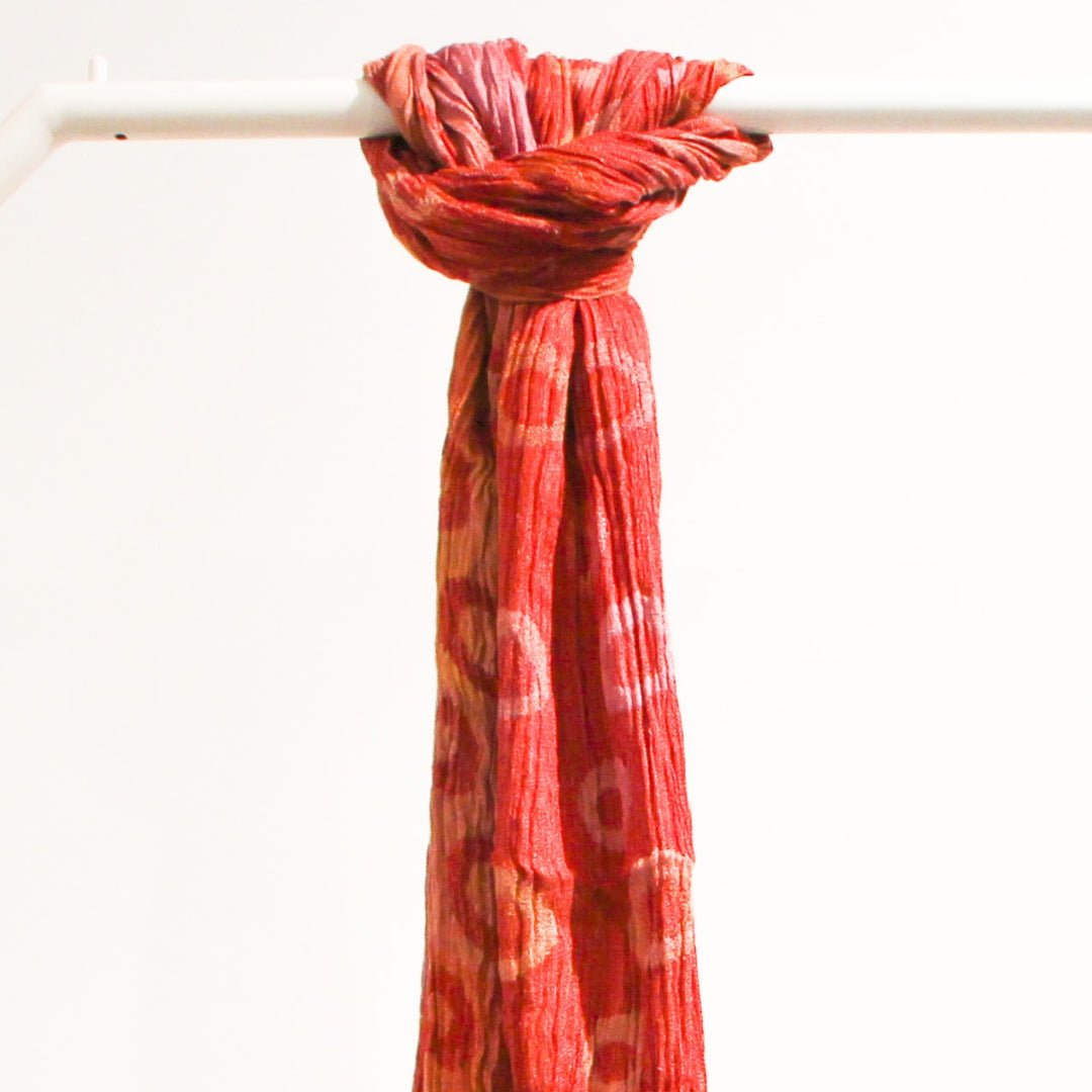 Handwoven silk scarf in a red polka dot design, lightweight artisan scarf, an elegant accessory for any season.