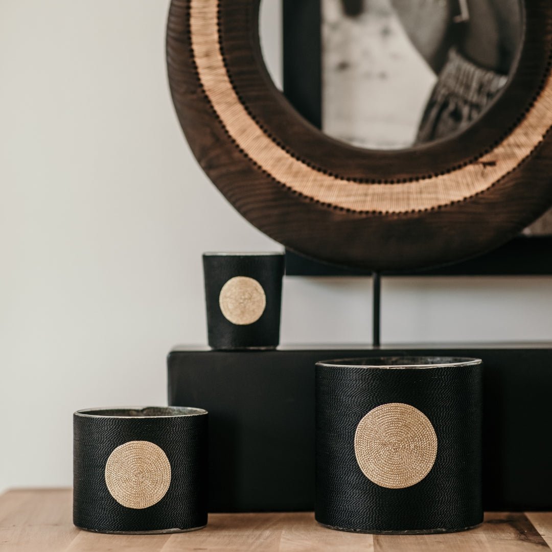 Oud scented candle wrapped in woven black plant silk with a golden ribbon, small size with a 40-hour burn