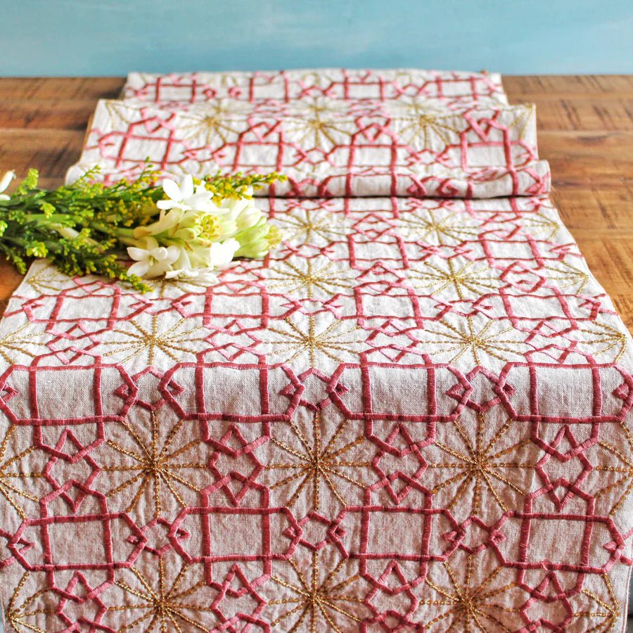 Hand-embroidered linen table runner in dusty pink silk with golden sitara detail and tassels, 40 x 228 cm