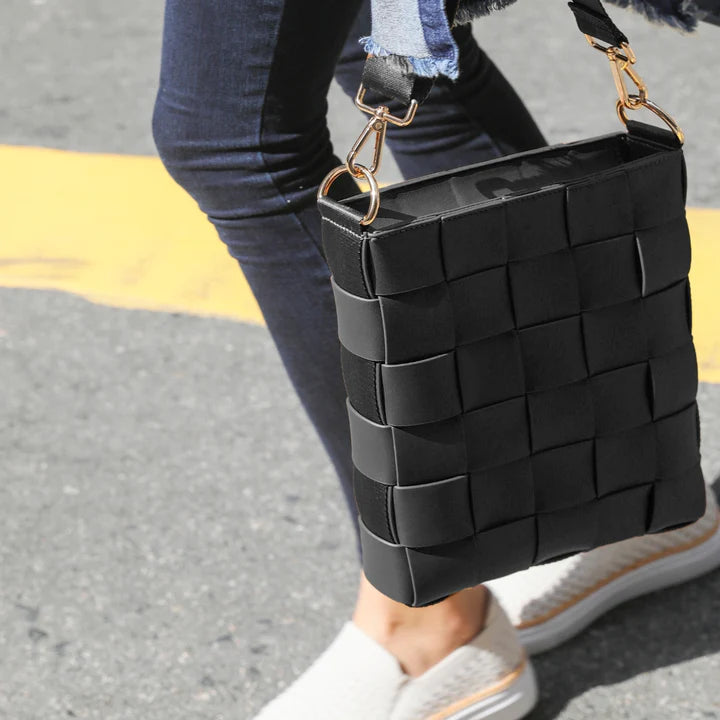 Braided strap bag in black, woven handbag with a braided handle, a stylish everyday shoulder or tote bag.