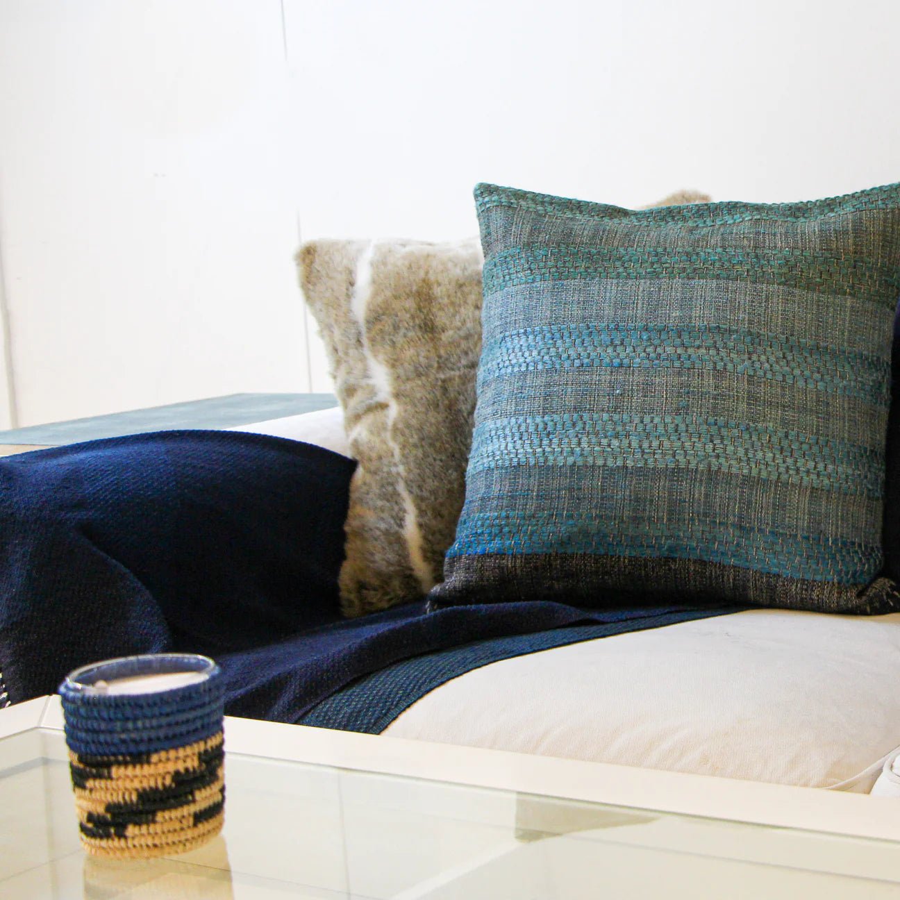 Handwoven silk and linen cushion in ocean black, an artisan scatter cushion adding texture to sofa or bed.