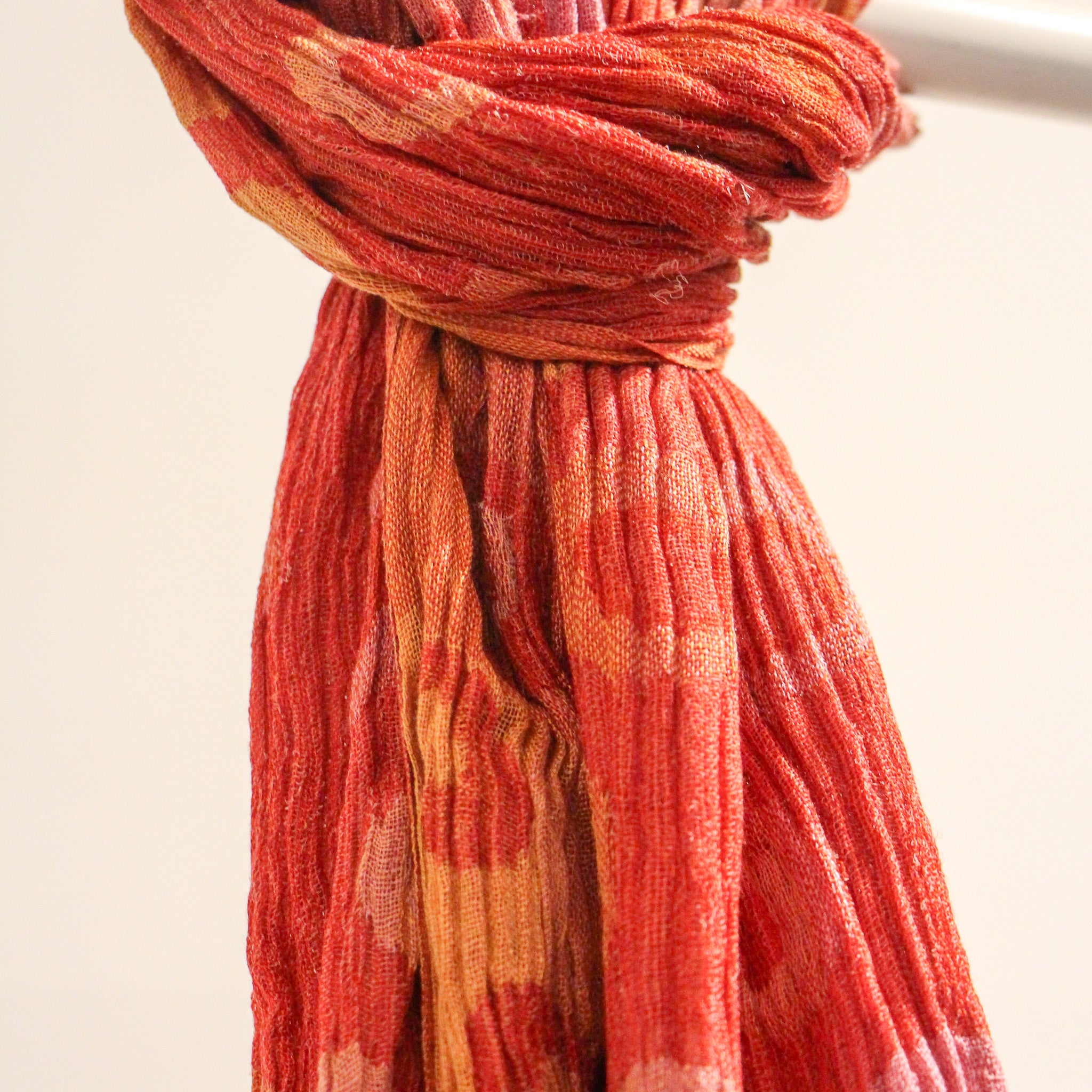 Handwoven silk scarf detail, red polka dot pattern, a soft lightweight artisan scarf and versatile accessory.