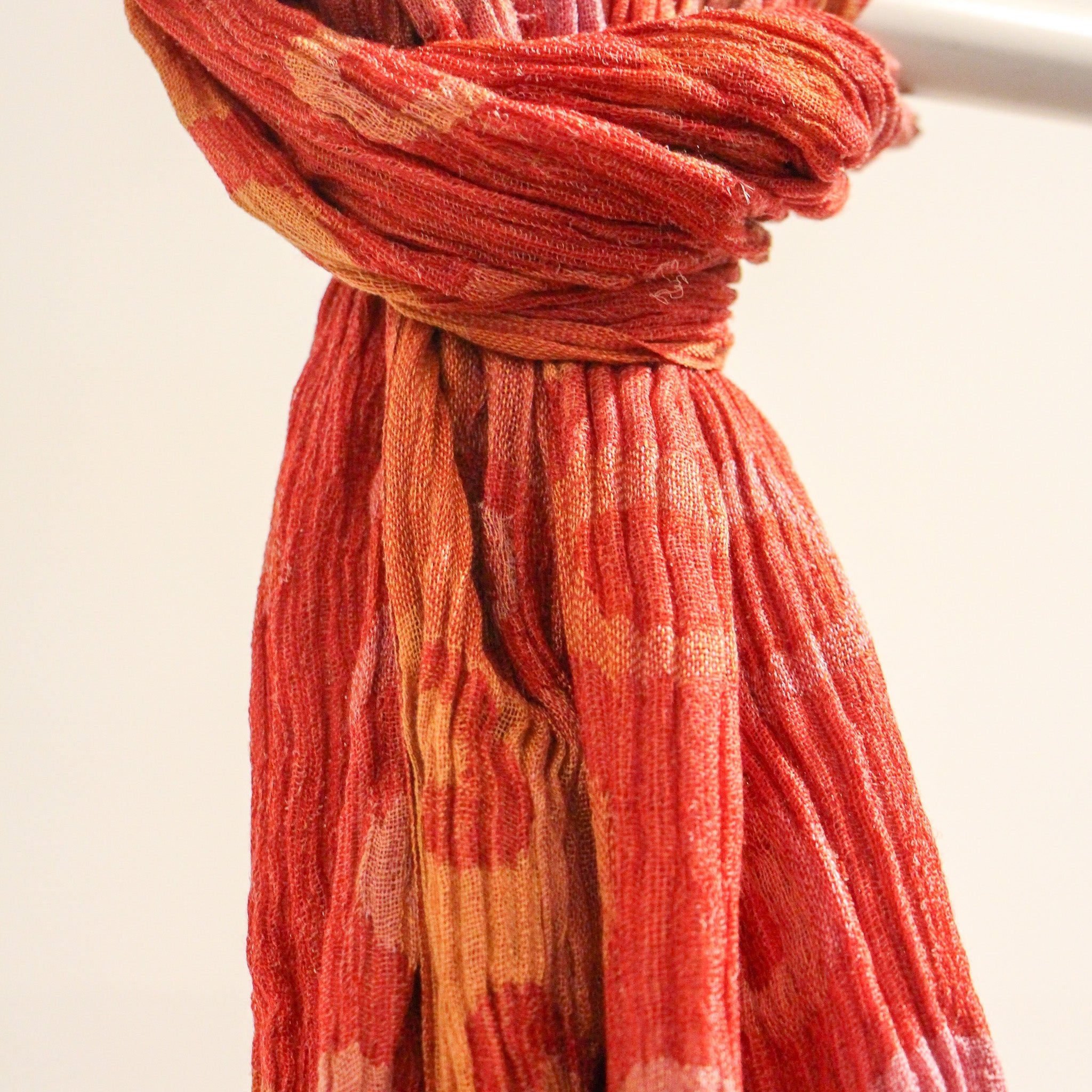 Handwoven silk scarf detail, red polka dot pattern, a soft lightweight artisan scarf and versatile accessory.
