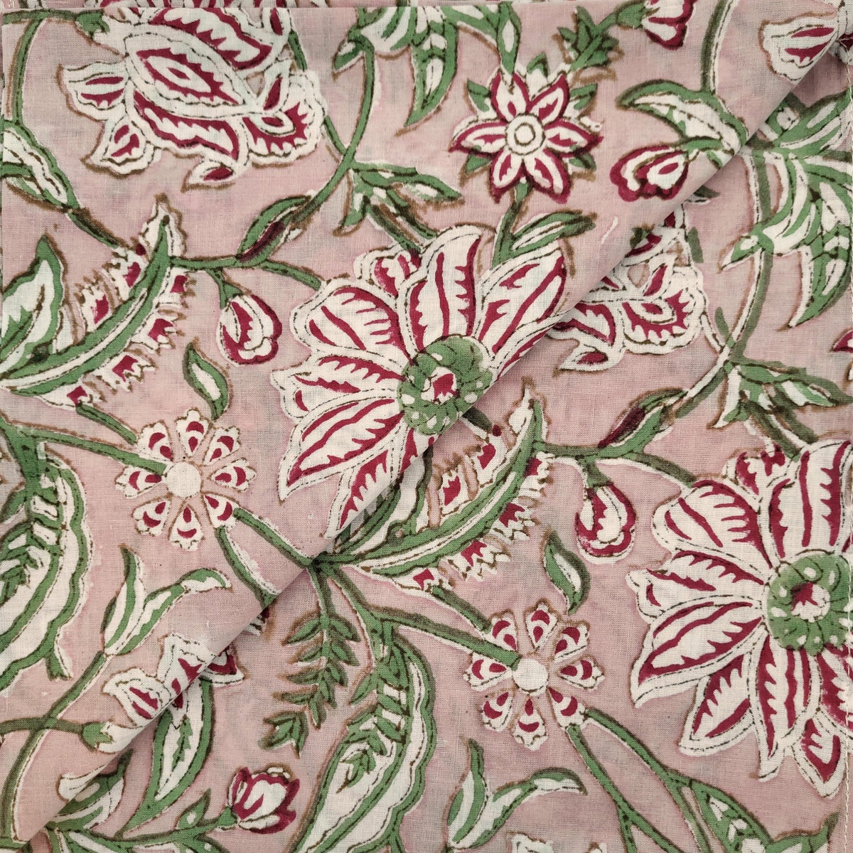 Gifts under $50 banner showing a pair of hand block printed cotton napkins in a dusty pink blossom design.