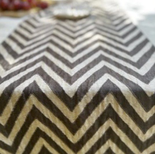Tuscan chevron runner by Saamro, plain and chocolate linen stitched in a chevron pattern with hand-crafted tassels.