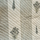 Reversible block print single quilt with a cypress tree and flower print in a plain white background design