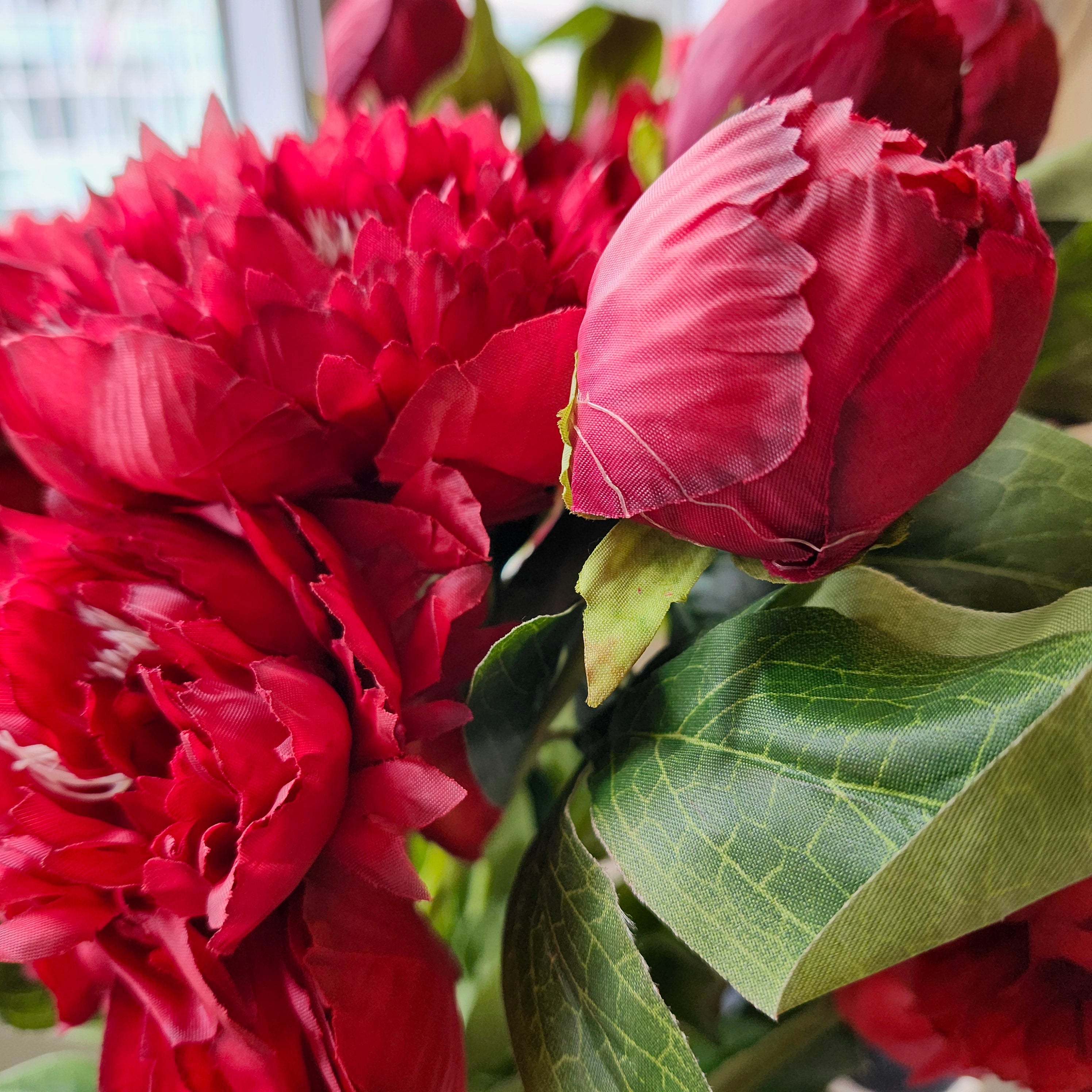 Vivid red artificial flower with two blooms and a bud on each bendable stem for floral displays