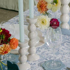 White bobbin candlestick from Inside Living, turned decorative candle holder for dining and home display, side view