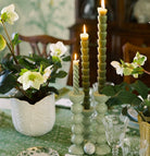 Sage lacquered bobbin candlestick in rubber wood for standard dinner candles, available in two sizes