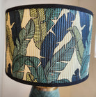 Green leaf-glazed ceramic table lamp with brass fittings and a screenprinted bamboo shade, 39cm high, made in Vietnam