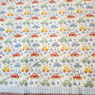 Machine washable car print child's quilt in soft organic cotton cambric, with a blue trellis pattern reverse