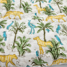 Reversible jungle print child's quilt, with a contrast chevron stripe pattern on the other side to use either way