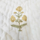 Reversible child's quilt, 40 x 60 inches, with a small marigold print on the reverse of the large yellow flowers