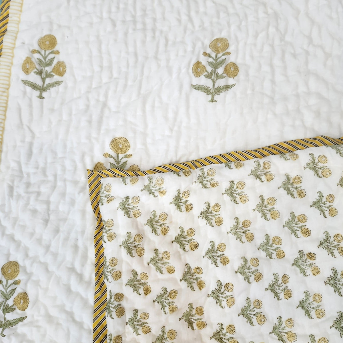 Yellow marigold block print child's quilt, machine washable, made from fine organic cotton cambric for a cot or bed