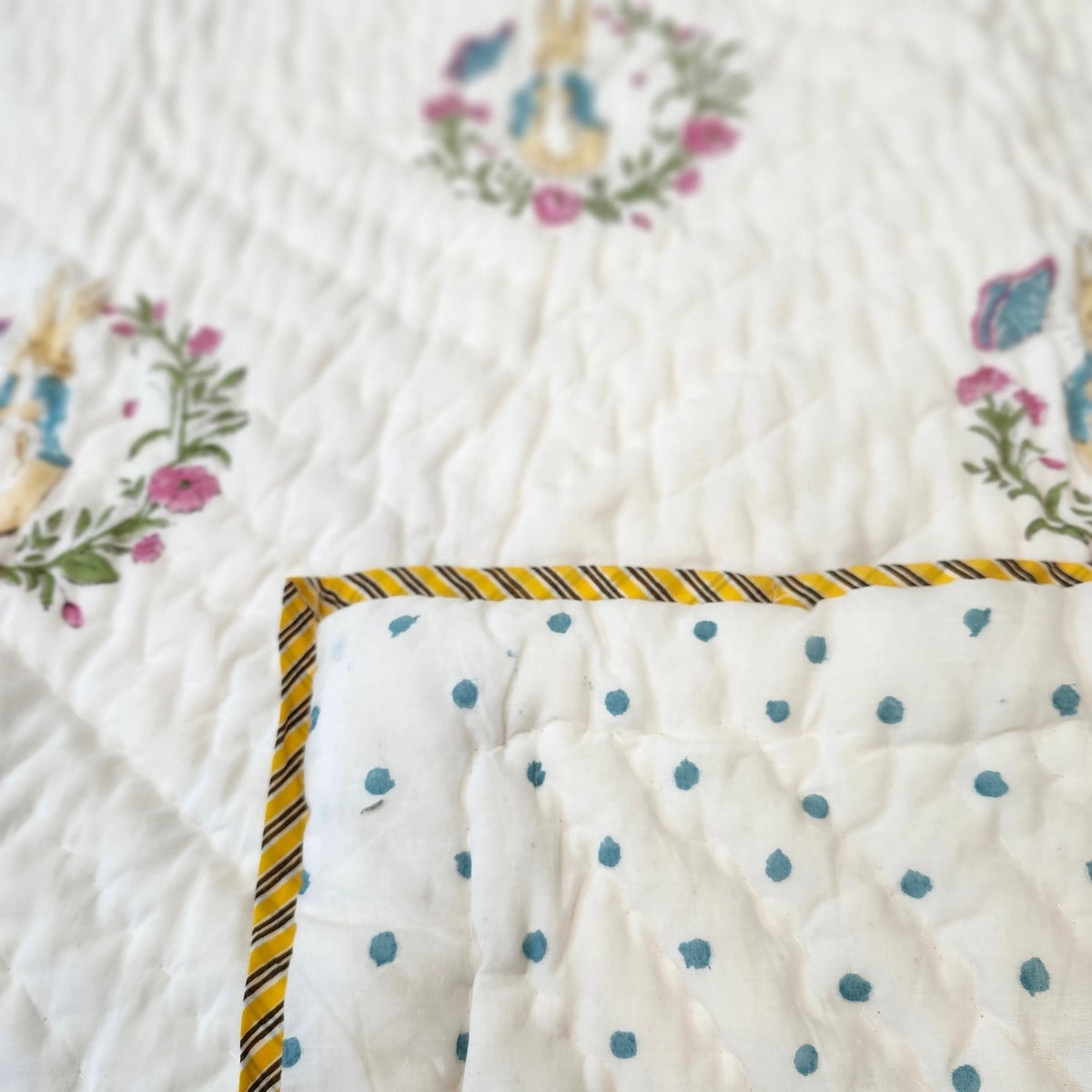 Peter Rabbit child's quilt, 40 x 60 inches, reversible with blue polka dots on a white ground on the other side