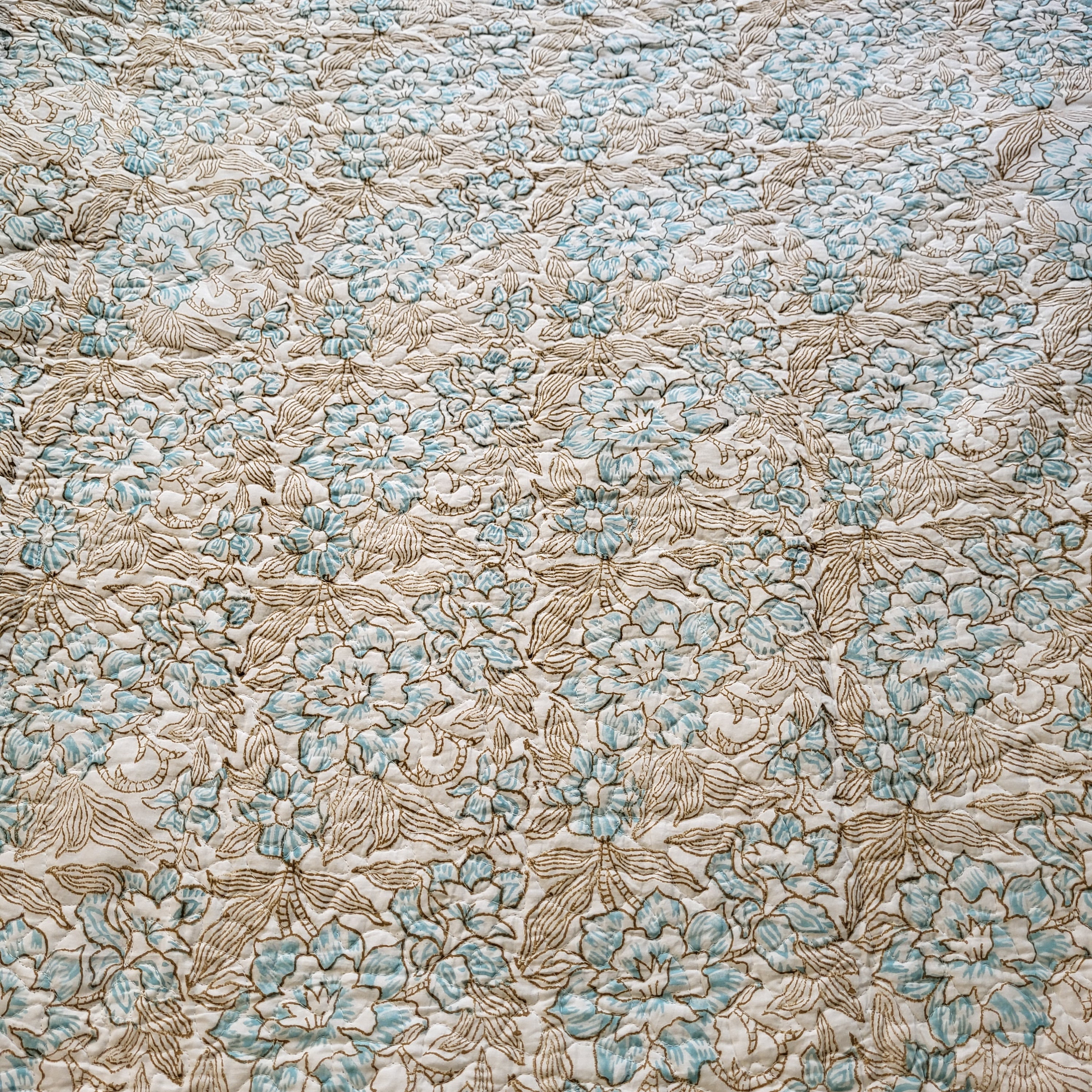 Block-print quilted king bedspread with pillowcases in blue and pink, from Inside Living Singapore Front view.