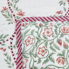 Green block print single quilt with a trellis print on a white background, reversible to a floral print