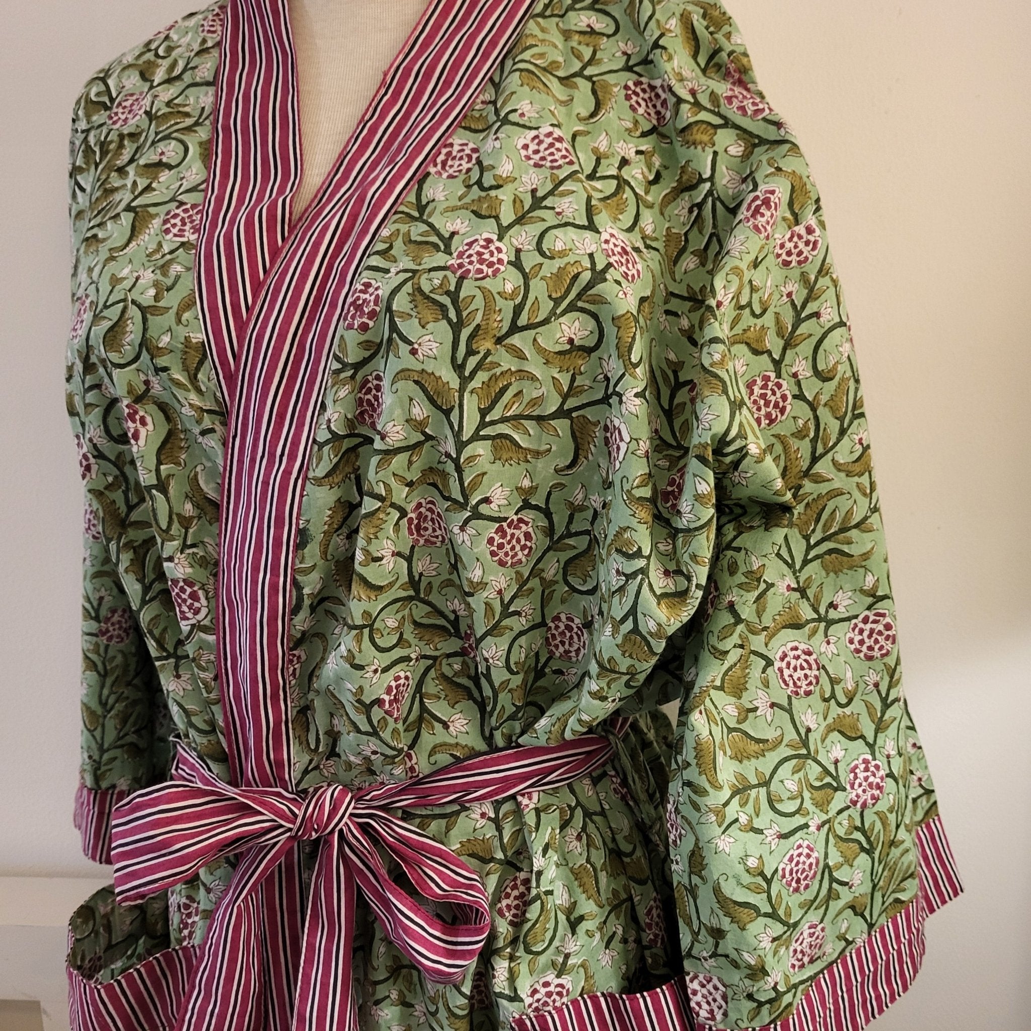 Block-printed cotton robe in a floral pattern on sage with contrast red trim, one size, machine wash