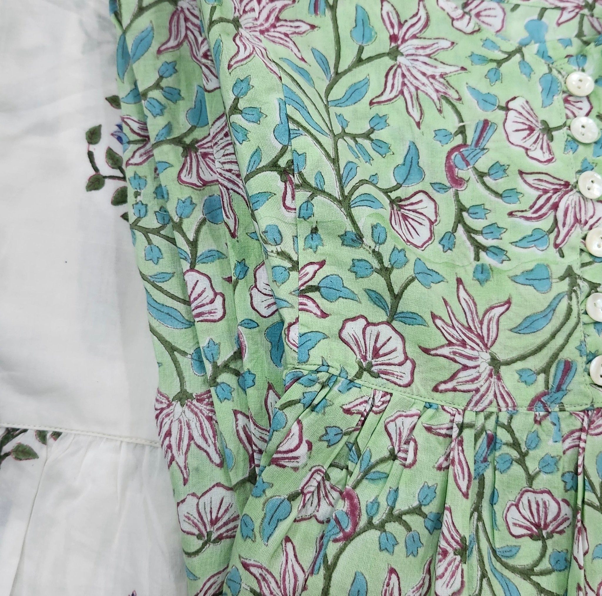 Another design of the block printed cotton sundress, showing the adjustable straps and the front mother of pearl buttons.