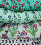 Lightweight cotton block printed sundress with mother of pearl buttons down the front and adjustable shoulder straps.