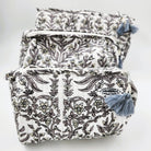 Block printed floral wash bag in grey, lined with four pockets and tassel zip, available in three sizes