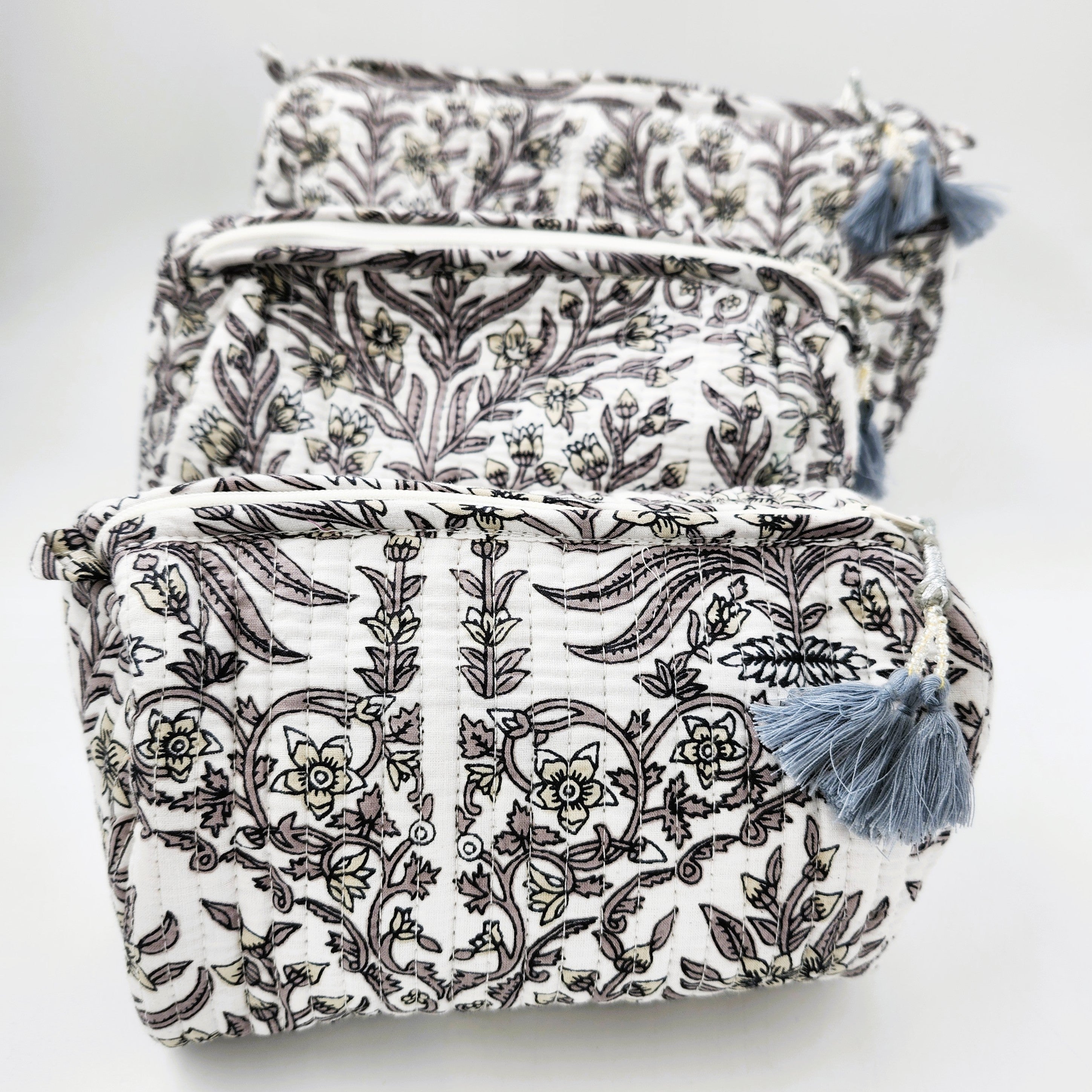 Block printed floral wash bag in grey, lined with four pockets and tassel zip, available in three sizes