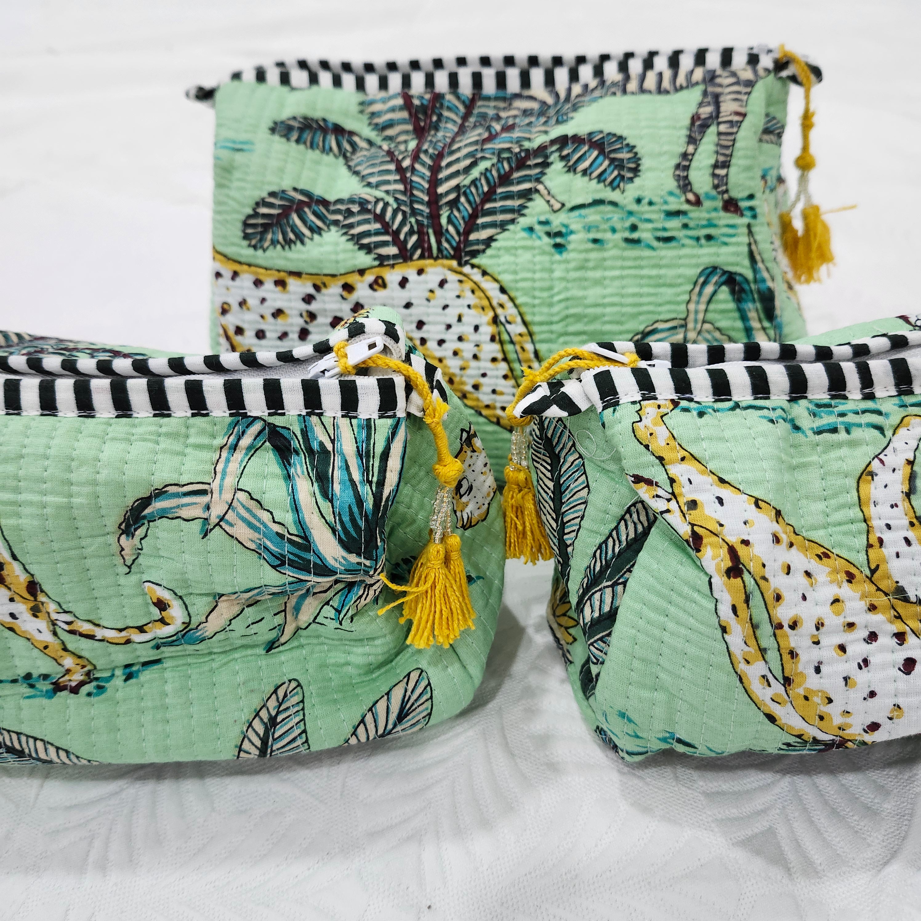 Block printed wash bag in safari print with zebras, birds, cheetahs and palms, tassel zip, three sizes