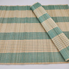 Bamboo placemat in turquoise, woven bamboo table mat, a natural eco-friendly dining accent in bright turquoise.